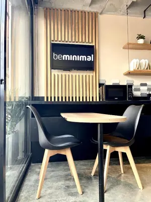 a table and two chairs in front of a counter at Beminimal Hotel in Medellín