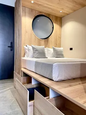 a bedroom with a large bed with a mirror at Beminimal Hotel in Medellín