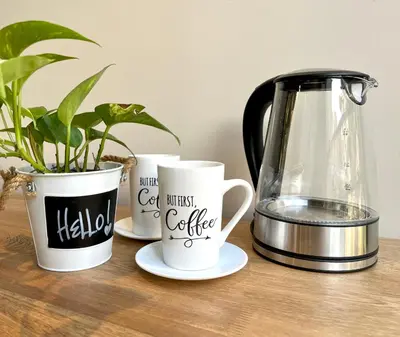 three coffee cups and a blender on a wooden table at Beminimal Hotel in Medellín