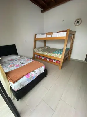 a bedroom with two bunk beds and a tiled floor at APARTAMENTO AMOBLADO SECTOR LAURELES-ESTADIO hasta 8 personas - Londres in Medellín