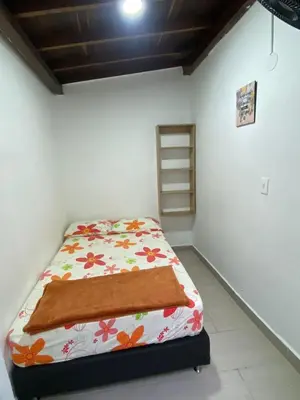 a small bedroom with a bed in a room at APARTAMENTO AMOBLADO SECTOR LAURELES-ESTADIO hasta 6 personas - Praga in Medellín
