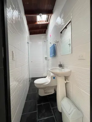 a white bathroom with a sink and a toilet at APARTAMENTO AMOBLADO SECTOR LAURELES-ESTADIO hasta 6 personas - Praga in Medellín