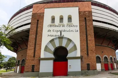 a building with a sign on the side of it at APARTAMENTO AMOBLADO SECTOR LAURELES-ESTADIO hasta 6 personas - Praga in Medellín