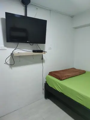 a room with a television on a wall with a bed at HABITACION AMOBLADA SECTOR LAURELES-ESTADIO #1 Madrid in Medellín