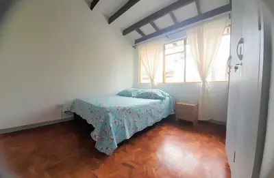 a bedroom with a bed in a room with a window at Casa Jaguar Manizales sector Cable in Manizales