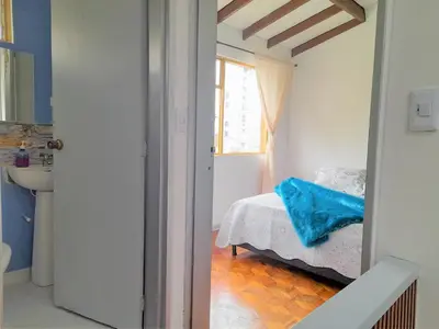 a small bedroom with a bed and a window at Casa Jaguar Manizales sector Cable in Manizales