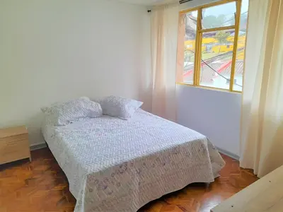 a bedroom with a bed and a window at Casa Jaguar Manizales sector Cable in Manizales