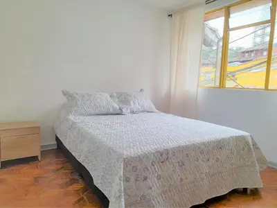a bed in a white room with a window at Casa Jaguar Manizales sector Cable in Manizales