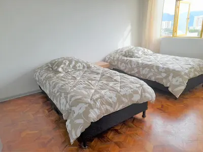 two beds sitting in a room with ainylinylinylinyl at Casa Jaguar Manizales sector Cable in Manizales