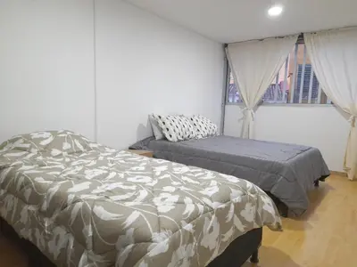 a bedroom with two beds and a window at Casa Jaguar Manizales sector Cable in Manizales