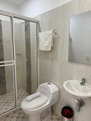 a bathroom with a toilet and a sink and a shower at Eco hotel el bosque in Doradal