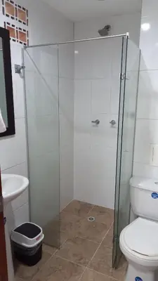 a glass shower in a bathroom with a toilet at Apartamento remodelado enLaureles 300mbps internet in Medellín