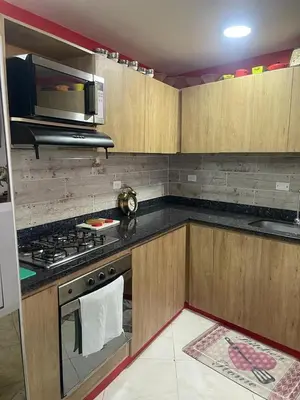 a kitchen with a stove and a microwave at Villa Chela, Hermosa casa de descanso, Venecia Antioquia in Venecia