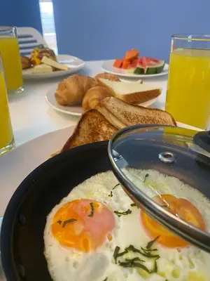 a table with a plate of eggs and toast at Brana by Bernalo Hotels in Medellín