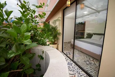 a balcony with a bed and plants in a room at Brana by Bernalo Hotels in Medellín