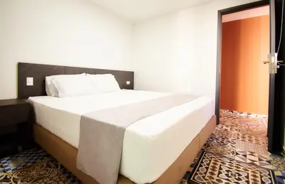 a bedroom with a large white bed in a room at Brana by Bernalo Hotels in Medellín