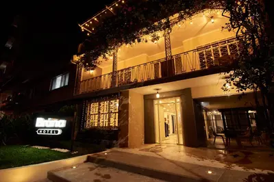 a building with a sign on the side of it at night at Brana by Bernalo Hotels in Medellín