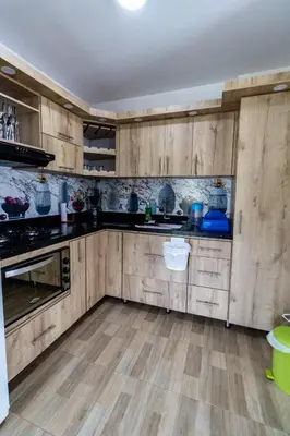 a kitchen with wooden cabinets and a counter top at Vista montaña Guatape by Hope in Guatapé