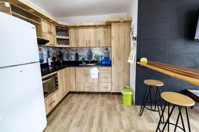 a kitchen with wooden cabinets and a white refrigerator at Vista montaña Guatape by Hope in Guatapé