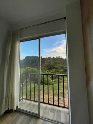 a room with a window with a view at Vista montaña Guatape by Hope in Guatapé