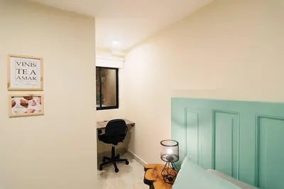 a bedroom with a desk and a chair in a room at Rinconcito Encantador in Medellín