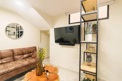 a living room with a couch and a table at Rinconcito Encantador in Medellín