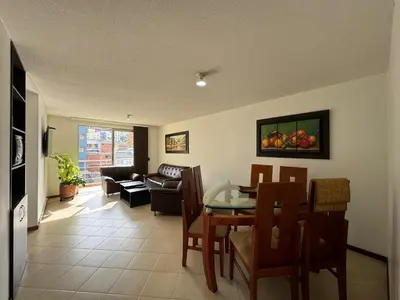 a living room with a table and chairs and a couch at MARGARETH in Manizales