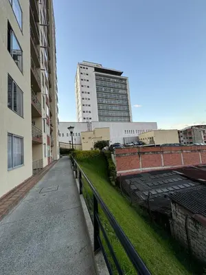 an empty street in a city with a tall building at MARGARETH in Manizales