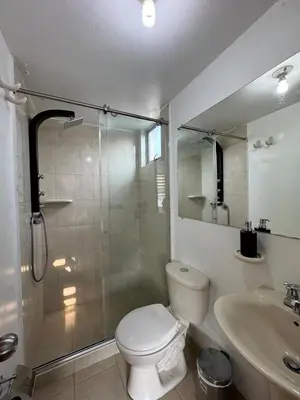 a bathroom with a shower and a toilet and a sink at MARGARETH in Manizales