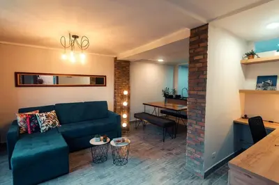 a living room with a couch and a dining room at Hermosa vista! Mejor ubicación! in Medellín