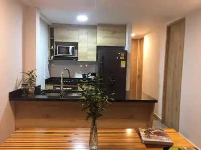 a kitchen with a sink and a black refrigerator at Hermosa vista! Mejor ubicación! in Medellín