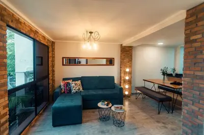 a living room with a blue couch and a table at Hermosa vista! Mejor ubicación! in Medellín