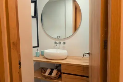 a bathroom with a sink and a mirror at Hermosa vista! Mejor ubicación! in Medellín