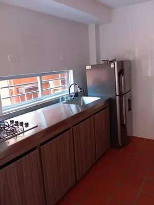 a kitchen with a sink and a stainless steel refrigerator at Cabaña con aire acondicionado San Jeronimo in San Jerónimo