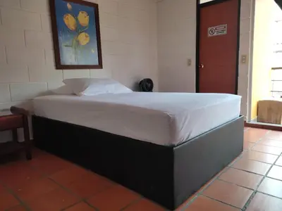 a large bed in a room with at Cabaña con aire acondicionado San Jeronimo in San Jerónimo
