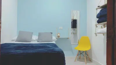 a bedroom with a bed and a yellow chair at Confortable Habitación en Apartamento Amoblado Jardin in Jardin