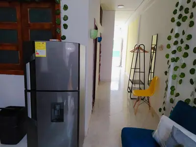 a kitchen with a stainless steel refrigerator in a room at Confortable Habitación en Apartamento Amoblado Jardin in Jardin