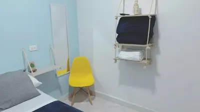 a room with a bed and a yellow chair at Confortable Habitación en Apartamento Amoblado Jardin in Jardin