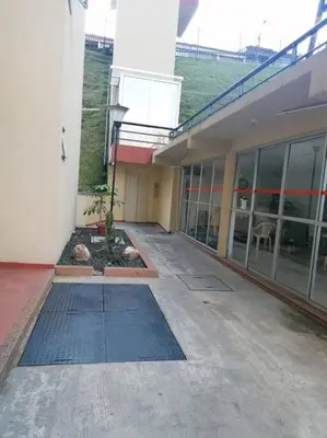 an empty hallway of a building with a plant at GIBRALTAR in Manizales