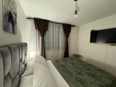 a hotel room with a bed and a flat screen tv at GIBRALTAR in Manizales