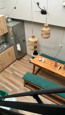 a kitchen with a table and two hanging baskets at Luum Casa Hotel Manila in Medellín