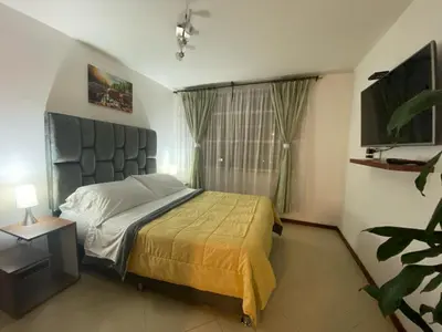 a bedroom with a bed and a large window at KOROLOVA in Manizales