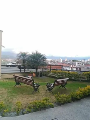 two benches in a park with a view of a city at KOROLOVA in Manizales