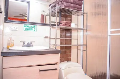 a bathroom with a toilet and a sink at Calle 8 Suites in Medellín
