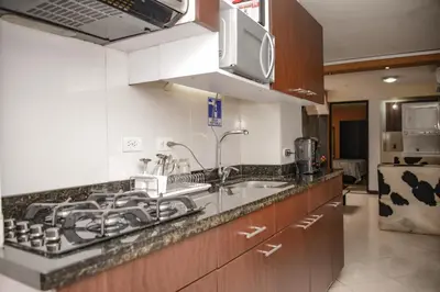 a kitchen with a sink and a microwave at Calle 8 Suites in Medellín