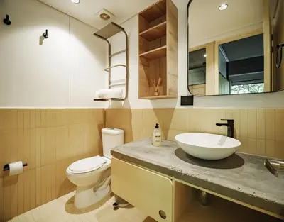 a bathroom with a sink and a toilet and a mirror at The Somos Flats Provenza in Medellín