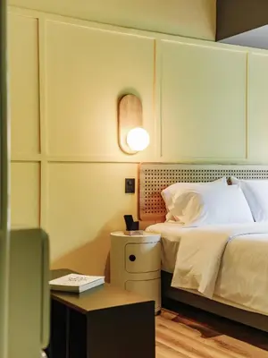 a hotel room with a bed and a desk at The Somos Flats Provenza in Medellín