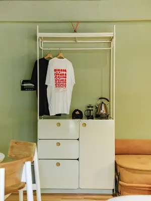 a closet with a dresser and a white shirt at The Somos Flats Provenza in Medellín