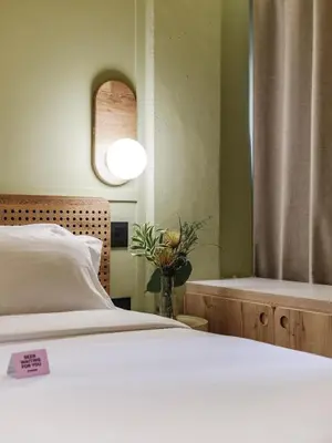 a bedroom with a white bed and a window at The Somos Flats Provenza in Medellín