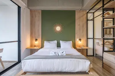 a bedroom with a large bed with two pillows at Lauret Lofts by Wynwood House in Medellín